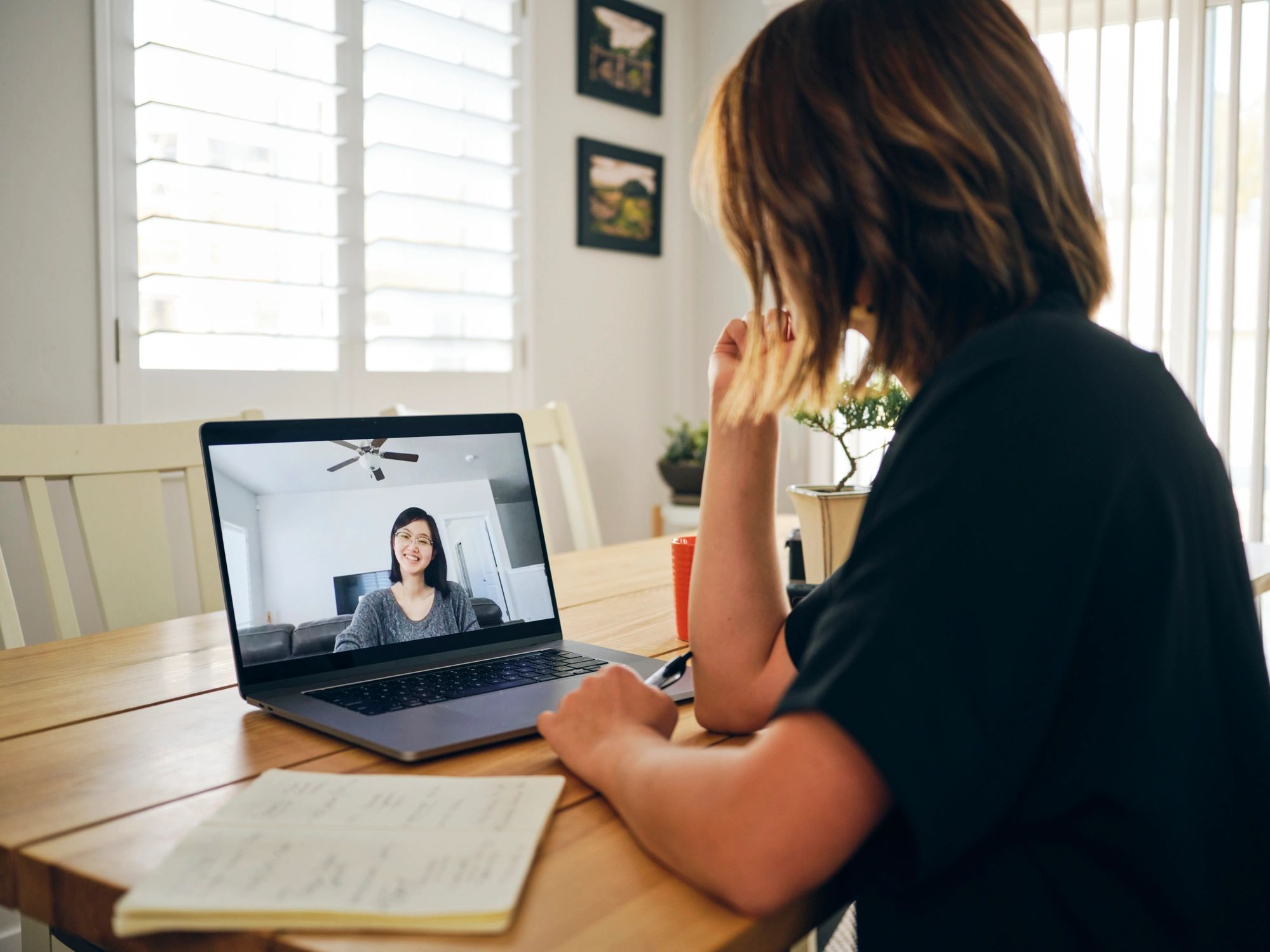 Client on a video call using a laptop at home
