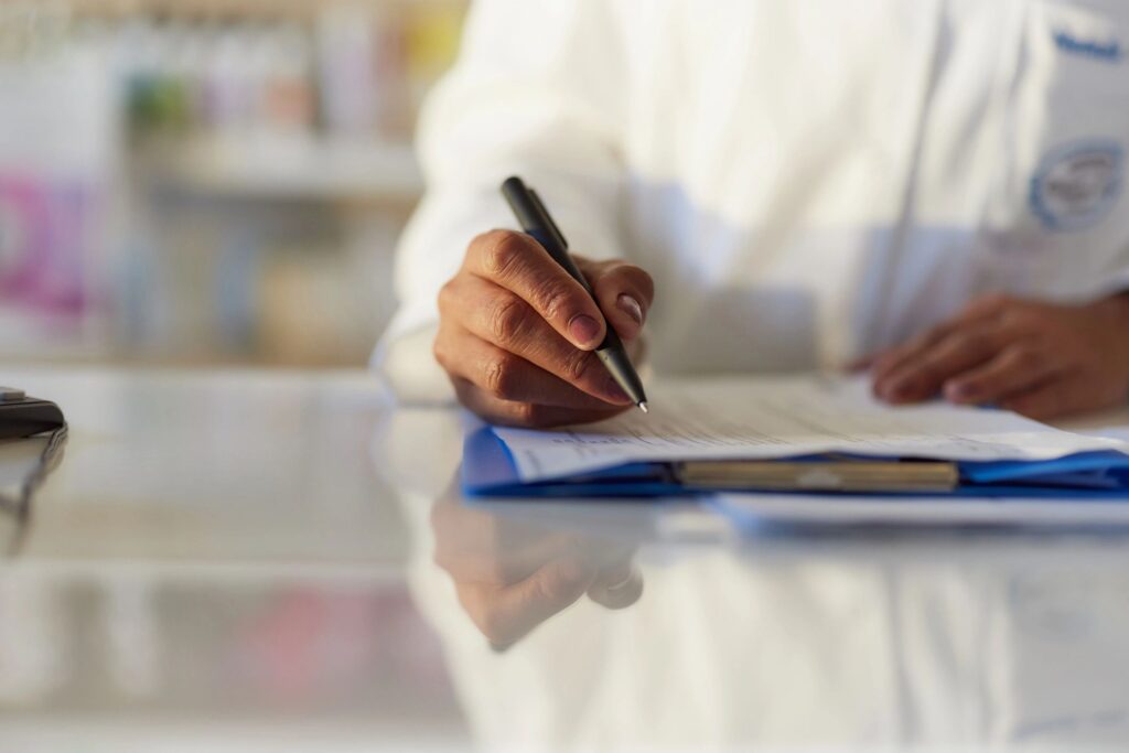Close up of taking notes in pharmacy.